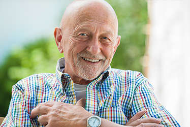 elderly man sitting and smiling