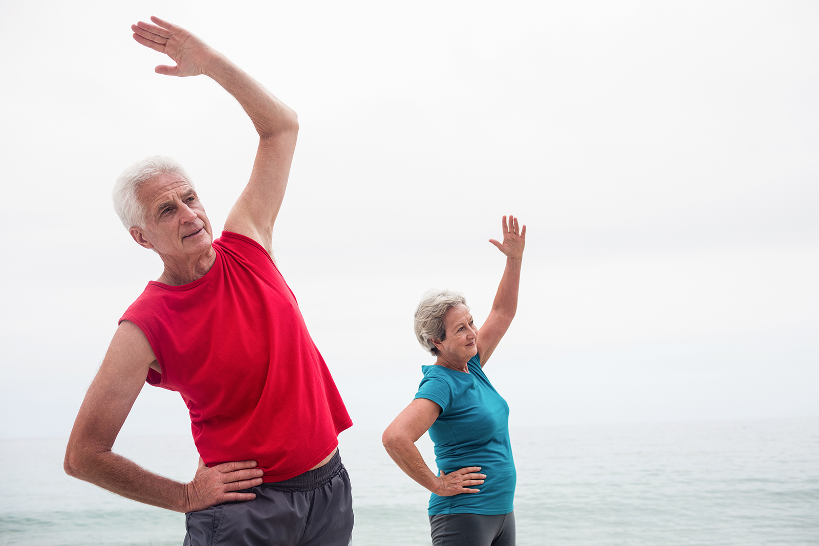 Senior couple performing stretching exercise