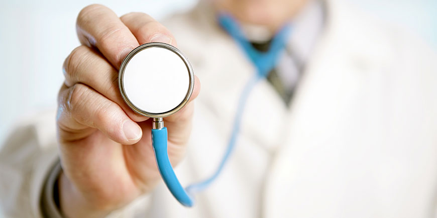 male doctor holding up stethoscope to camera 