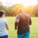 man and woman running side by side through a park