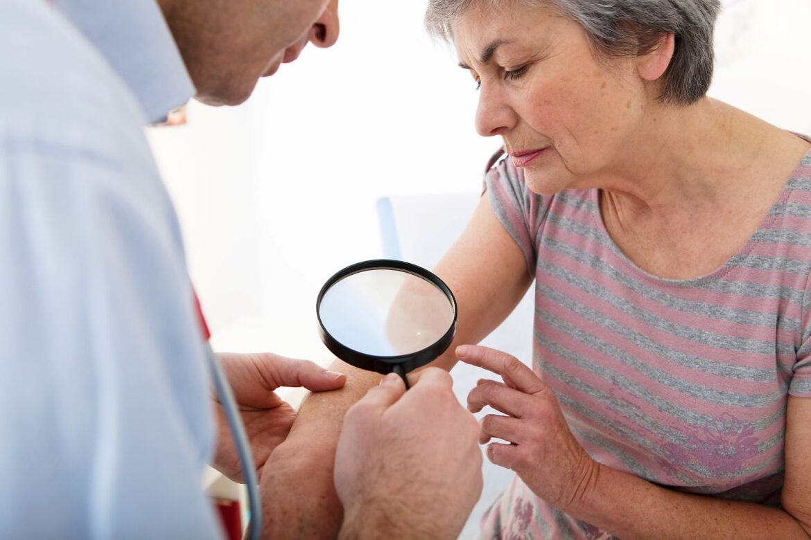 Doctor treating patient with skin condition